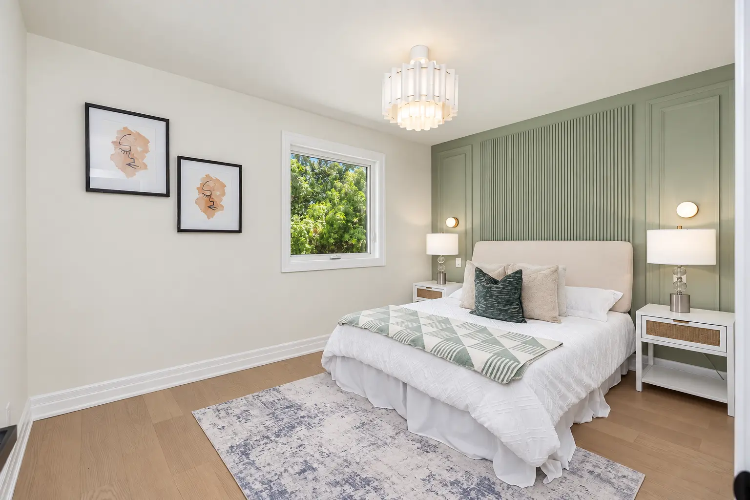 Completed bedroom with a sage green panelled feature wall